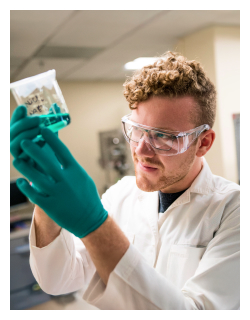 Scientist looking at liquid in a container